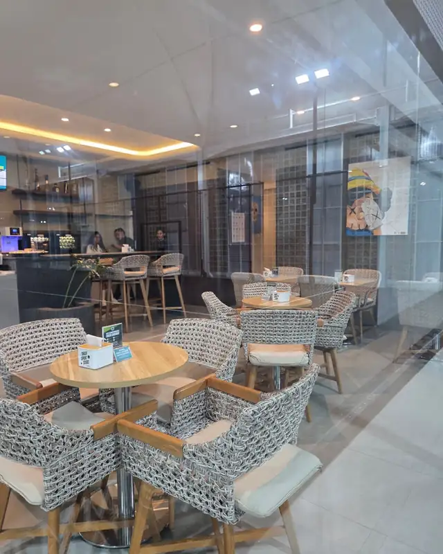 Cafe seating with wicker chairs and round tables